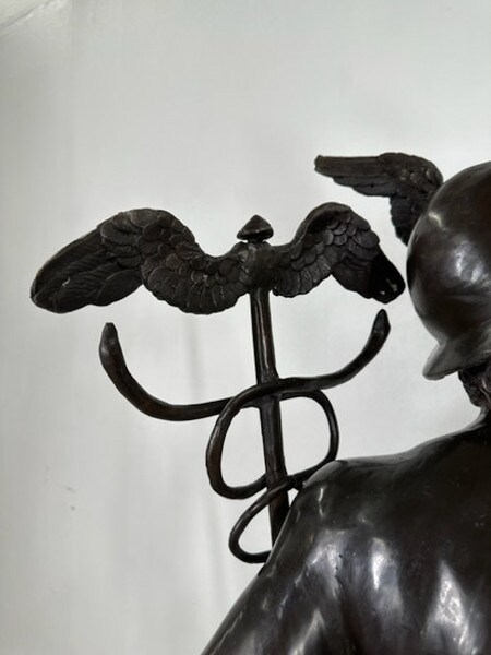 Statue of the flying Mercury wings on his feet and a caduceus sculpture